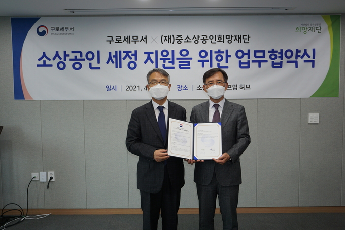 박진하 서장(왼쪽)과 민홍기 (재)중소상공인희망재단 이사장이 업무협약 체결 기념사진을 찍고 있다.