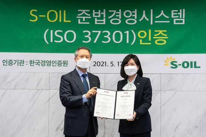 S-OIL 박성우 법무/컴플라이언스 본부장(왼쪽)과 황은주 한국경영인증원장이 준법경영시스템 국제표준 ISO 37301 인증서 수여식을 가진 뒤 기념촬영을 하고 있다. (사진=S-OIL)