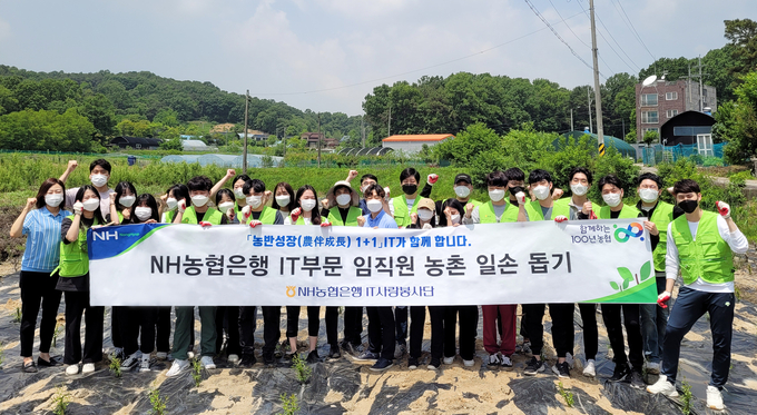 지난 24일 IT부문 신규직원들이 일손돕기를 마친 후 기념 촬영을 하고 있다.(사진=NH농협은행)