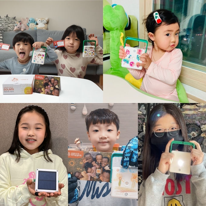 롯데칠성음료 임직원 자녀들이 직접 만든 태양광 랜턴을 들고 있다.(사진=롯데칠성음료)