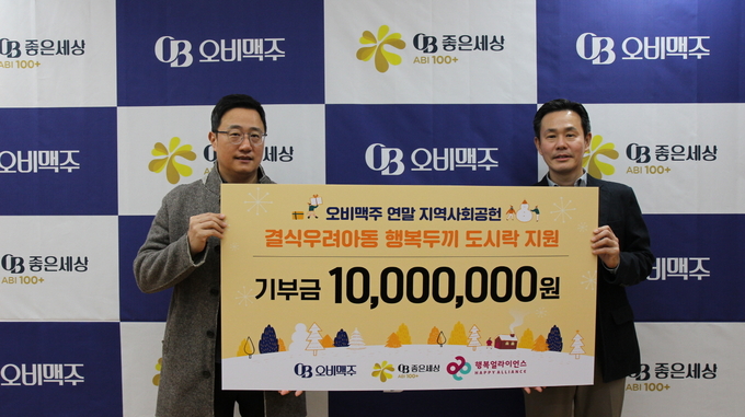 구자범(왼쪽) 오비맥주 법무⋅정책홍보부문 수석부사장과 조민영 행복얼라이언스 사무국 본부장이 24일 결식우려아동 행복도시락 지원전달식에서 기념촬영을 하고 있다. (사진제공=오비맥주)