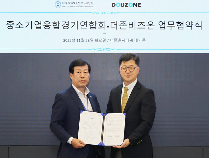 지용구(오른쪽) 더존비즈온 솔루션사업부문 대표가 장승원 ㈔중소기업융합경기연합회 회장과 디지털 전환(DX) 지원을 위한 업무협약을 체결하고 있다. (사진=더존비즈온)