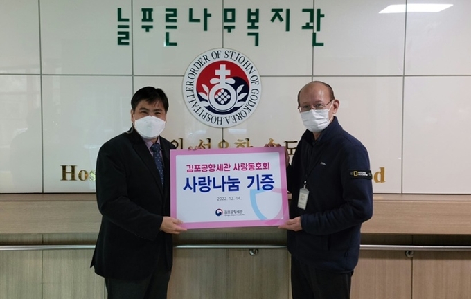 임현철<왼쪽> 김포공항세관장이 늘푸른나무복지관을 찾아 후원물품과 성금을 전달하고 있다.