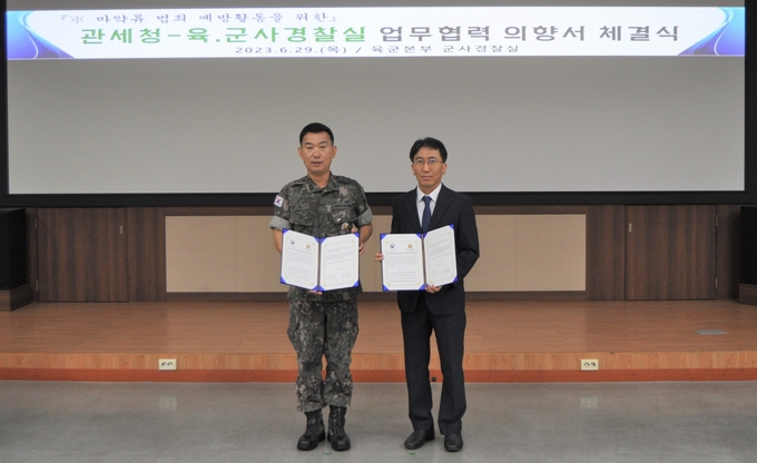 한창령<오른쪽> 관세청 조사국장과 박헌수 육군 군사경찰실장이 29일 충남 계룡대 육군본부에서 마약 확산 방지를 위한 상호협력 의향서를 체결하고 있다.