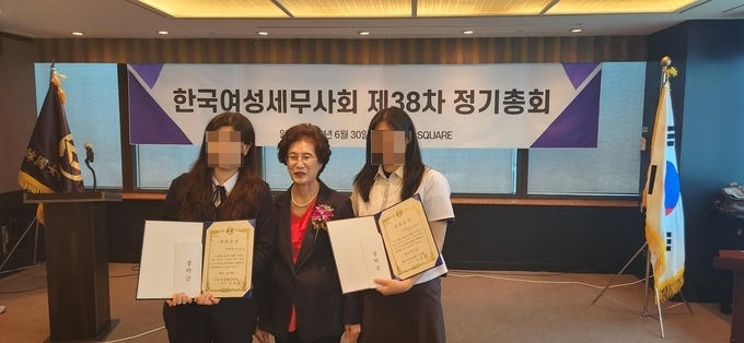 이찬희 회장이 인천세무고 등 2명의 학생에 장학금을 전달하고 있다. 여성세무사회는 이번 총회에서 4명의 학생에게 장학금을 전달했다.