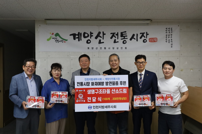 김명진 회장과 인천지방회 임원들이 계양산전통시장상인연합회에 생명구조타올을 전달하고 있다. 
