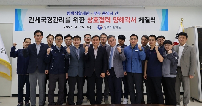 양승혁 평택직할세관장<왼쪽 여덟번째>은 25일 평택당진항 부두운영사 21개 업체와 상호협력 업무협약을 체결했다.