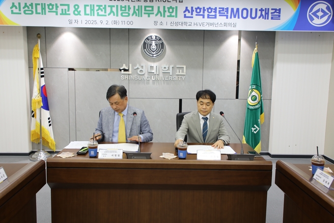 신용일 대전세무사회장(오른쪽)과 서명범 신성대 총장이 업무협약을 체결하고 있다. 